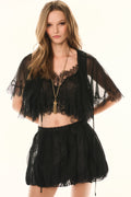 Woman wearing a black lace outfit on a white background